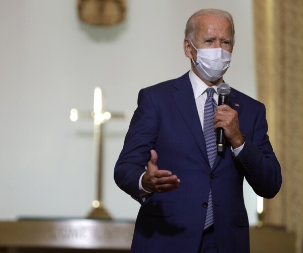 biden campaign in Wisconsin wearing a purple tie at a church