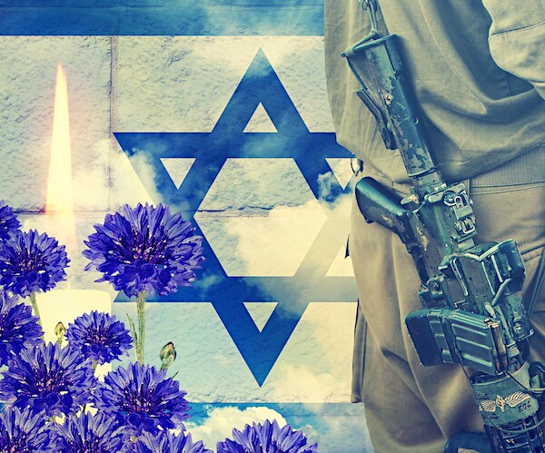Soldier of Israeli defense forces against Israeli flag and sky background. Ceremonial burning candle and blue flowers