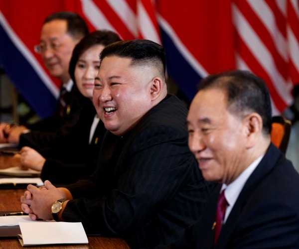 North Korean leader Kim Jong Un smiles during a meeting