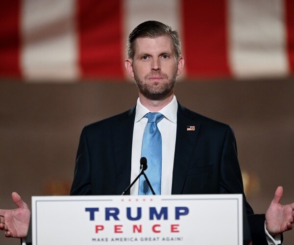 eric trump  with hands outstretched
