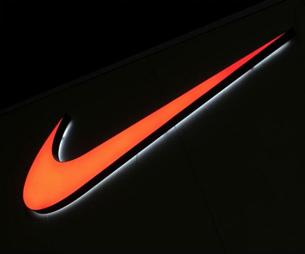 nike swoosh is shown in orange