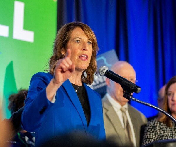 axne in a bright blue blazer 