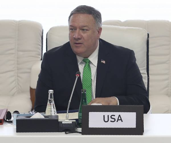 pompeo seated at a table labled u s a
