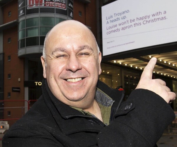 luis troyano points at sign