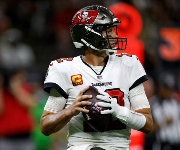 tom brady holds a football