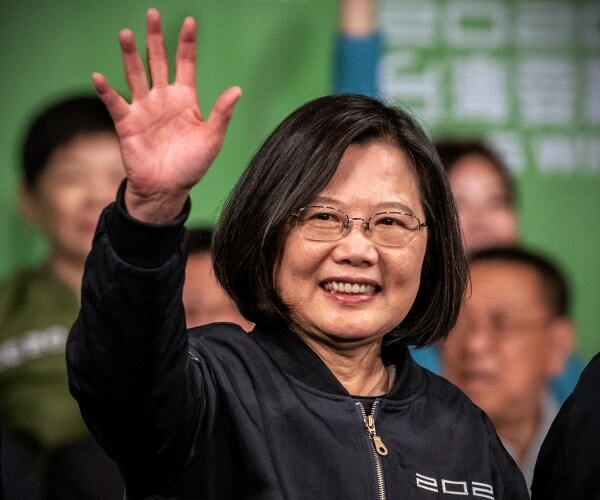 Tsai Ing-Wen waves after addressing supporters following her re-election as President of Taiwan