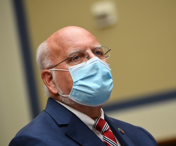 redfield in a navy blue suit and blue mask