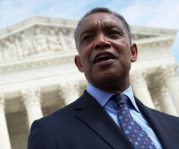 karl racine speaks into mic in front of supreme court