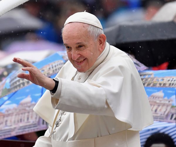 pope francis wearing white extends left arm
