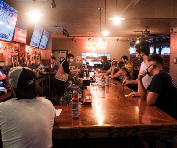 customers enjoy drinks in bar