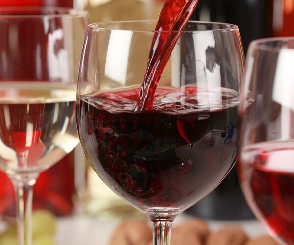 red wine being poured into a glass