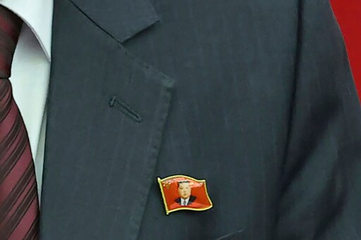 North Koreans Are Seen Wearing Kim Jong Un Pins for the First Time as His Personality Cult Grows