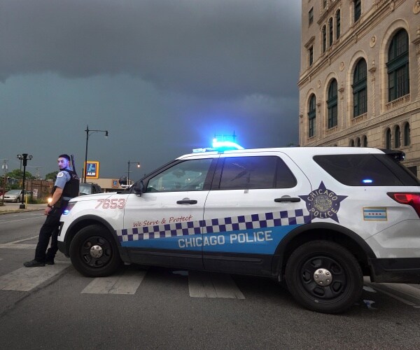 chicago police officer stands by his car