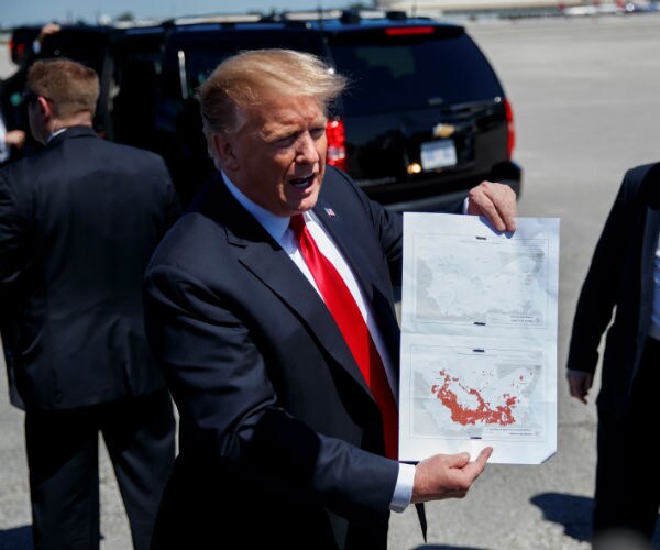 us president donald trump holding a map of syria