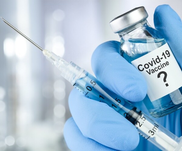covid vaccine in a bottle with syringe