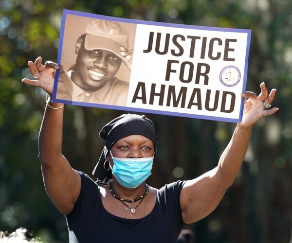 A woman holds up a sign board