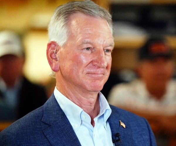 a man wearing a suit looks on