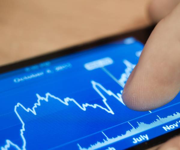 a person checking stocks on a smart phone