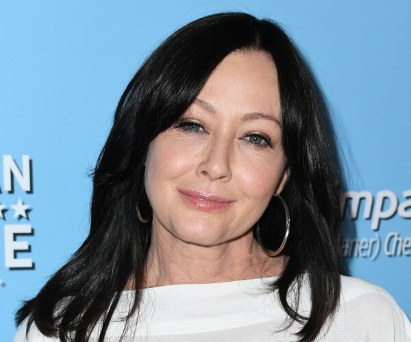 doherty in a white dress and hoop earrings