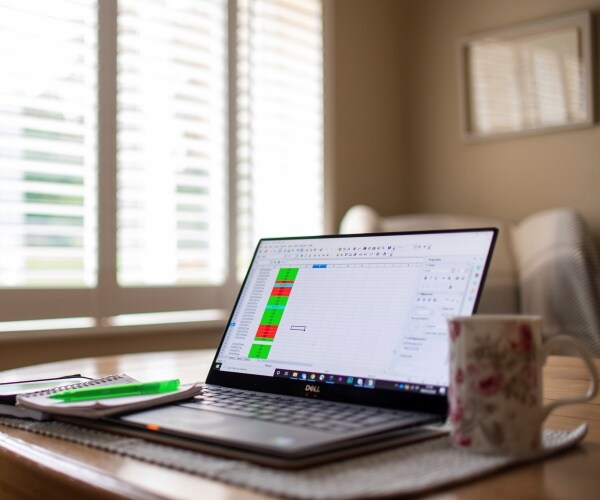 a laptop on a dining room table set up as a remote office to work from home