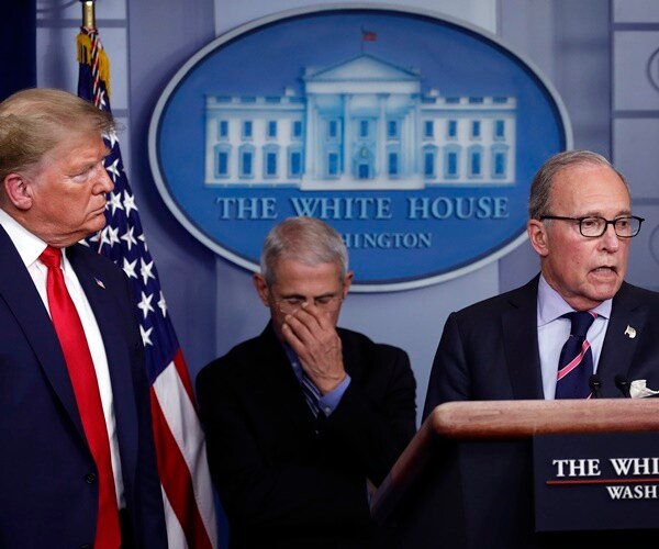 dr. anthony fauci bows his head in shame as he listens to larry kudlow as president donald trump looks on