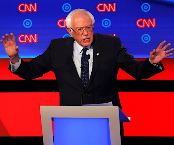bernie sanders throws his hands up during the democratic primary presidential debate