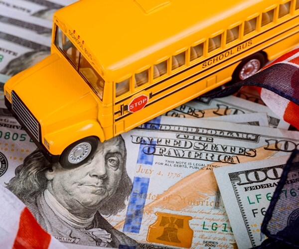 toy yellow school bus , american us flag and dollar cash money 