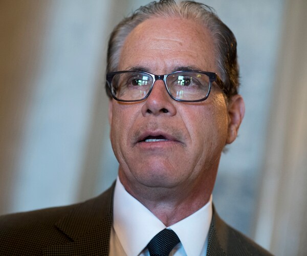 mike braun stands and listens during a media scrum