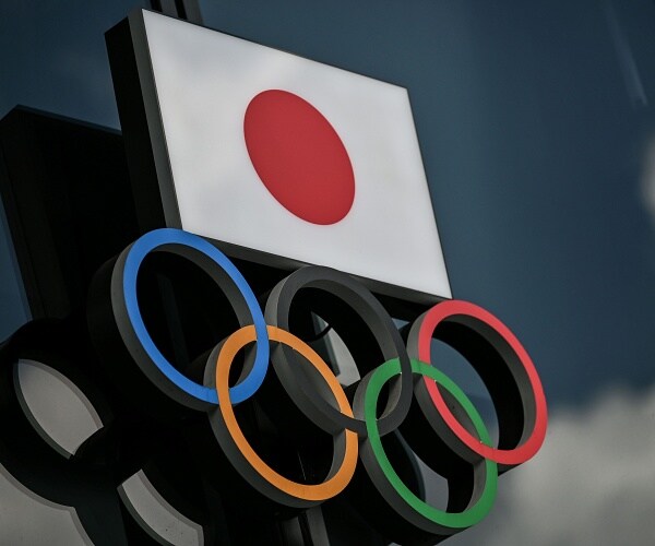 japanese flag above olympic rings