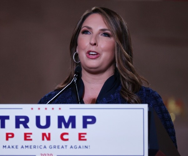 ronna mcdaniel stands behind podium