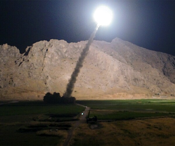 an iranian missile takes off into the night