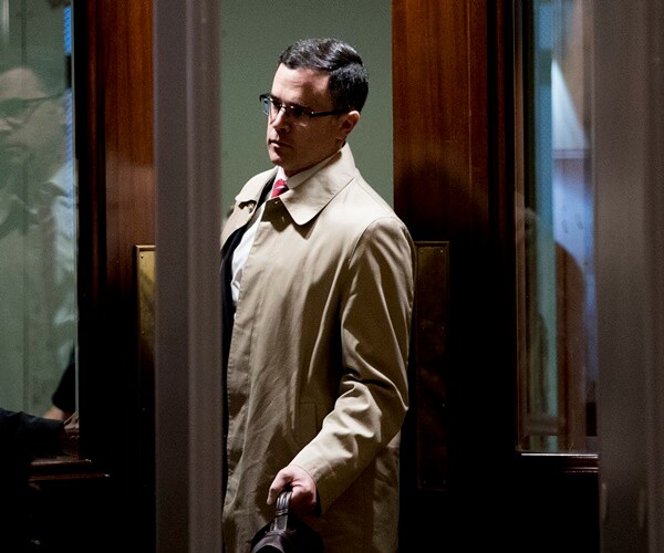 tim morrison arrives for testimony in his trenchcoat