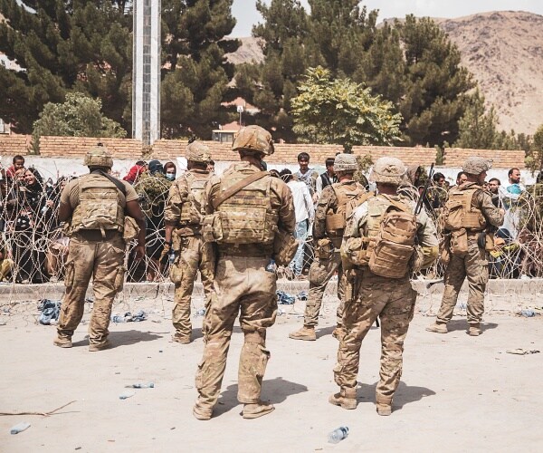american soldiers stand guard at airport fence