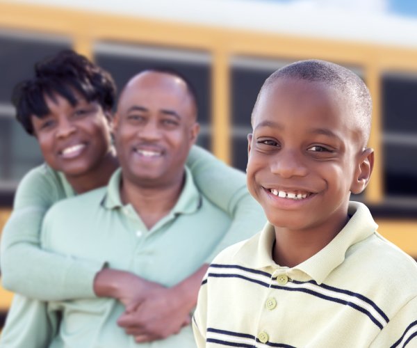 student and parents smile