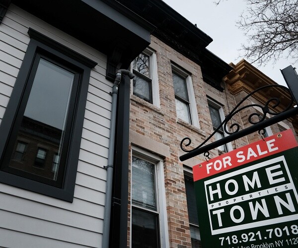 for sale sign in front of row home