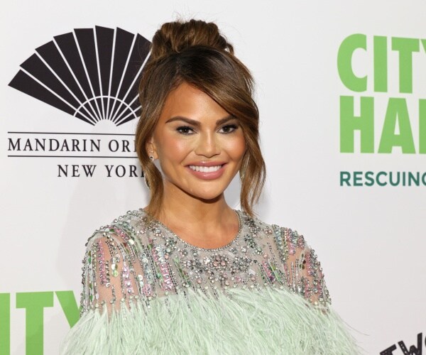 chrissy teigen smiles for the camera