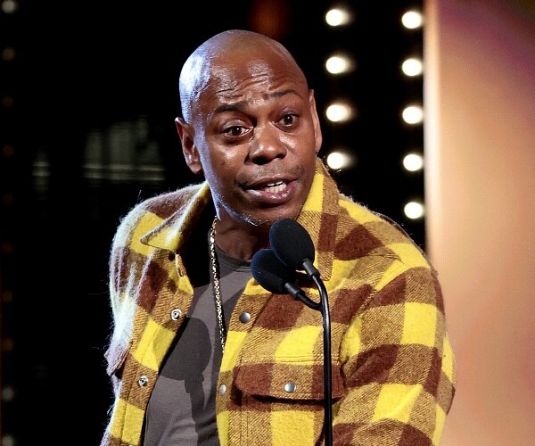 dave chappelle speaks into mic onstage