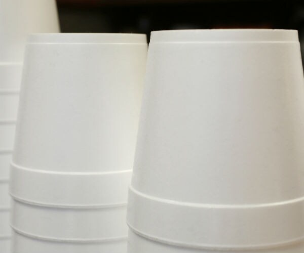 polystyrene foam soup containers are stacked in a restaurant