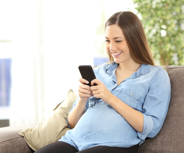 a pregnant woman using a cell phone