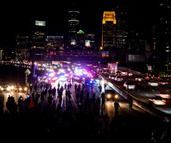 demonstrator march on a freeway