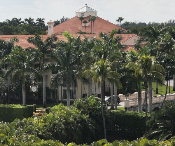 A building is seen surrounded by palm trees on the grounds of the Trump National Doral golf resort. 