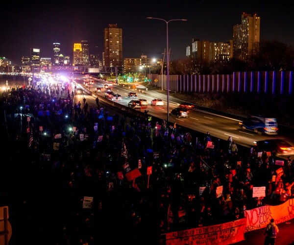 protestors walk down highway