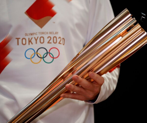 greek singer sakis rouvas holds a 2020 olympic torch in athens