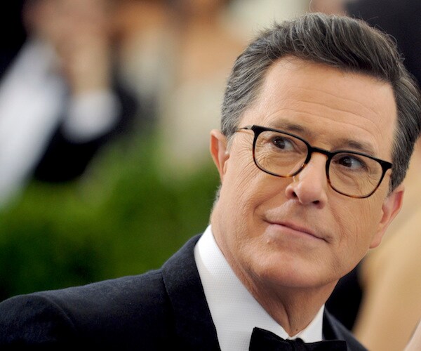 stephen colbert looks back over his right shoulder
