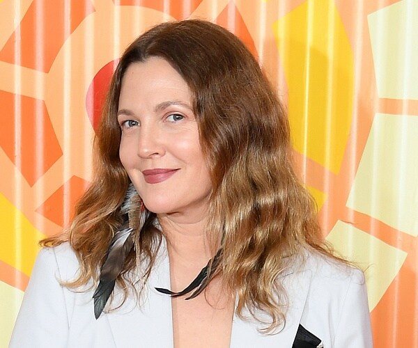 drew barrymore stands on red carpet