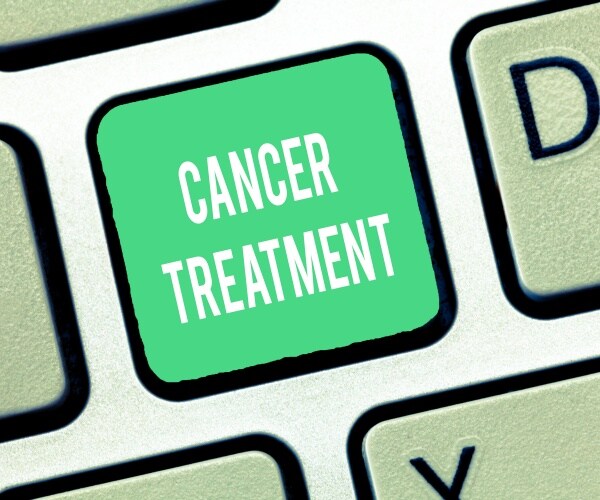 keyboard with a key that says 'cancer treatment'