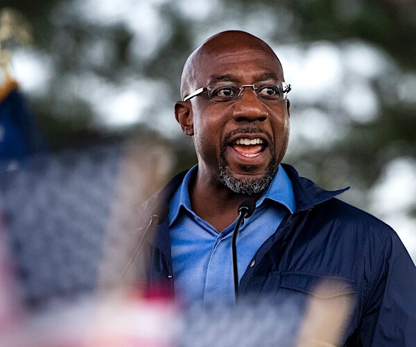 raphael warnock speaks during a campaign rally