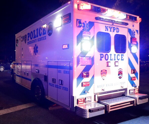 a new york police department truck is flashing its lights to respond to a criminal investigation