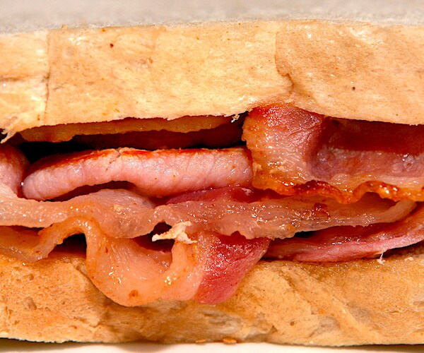 a sandwich of processed meat, including bacon and ham