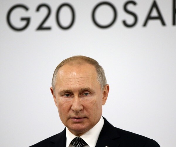 vladimir putin answers questions at a press ocnference at the g20 summit in osaka, japan.